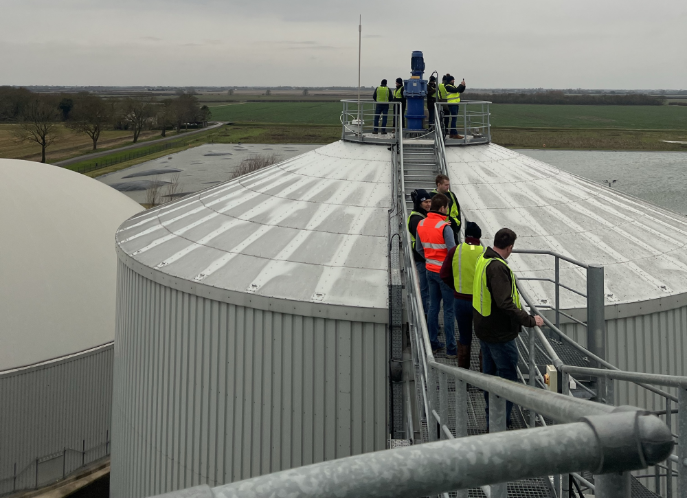 Farmers inspecting anaerobic digesters